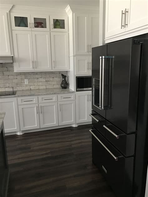 black cabinets with black steel fridge|black and white kitchen cabinets.